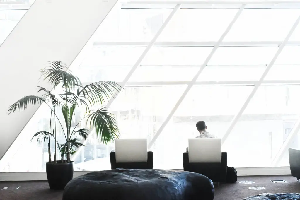 Bright office with glass walls and seating, electrical refurbishment by CIC Ltd