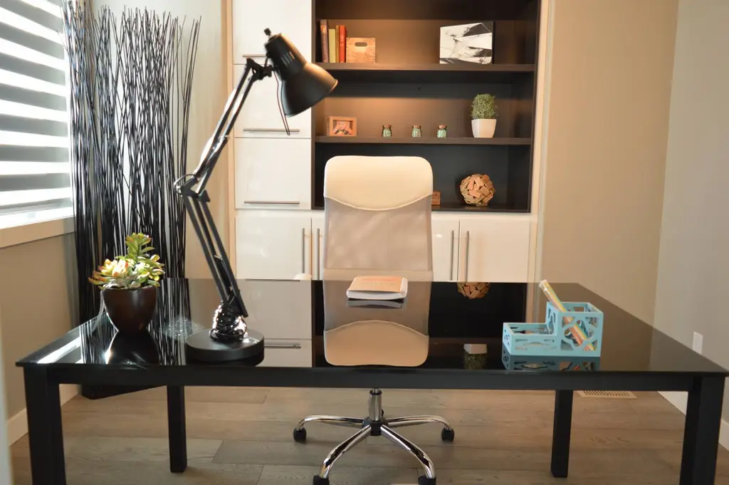 Office desk with lamp and shelving, practical lighting and power by CIC Ltd