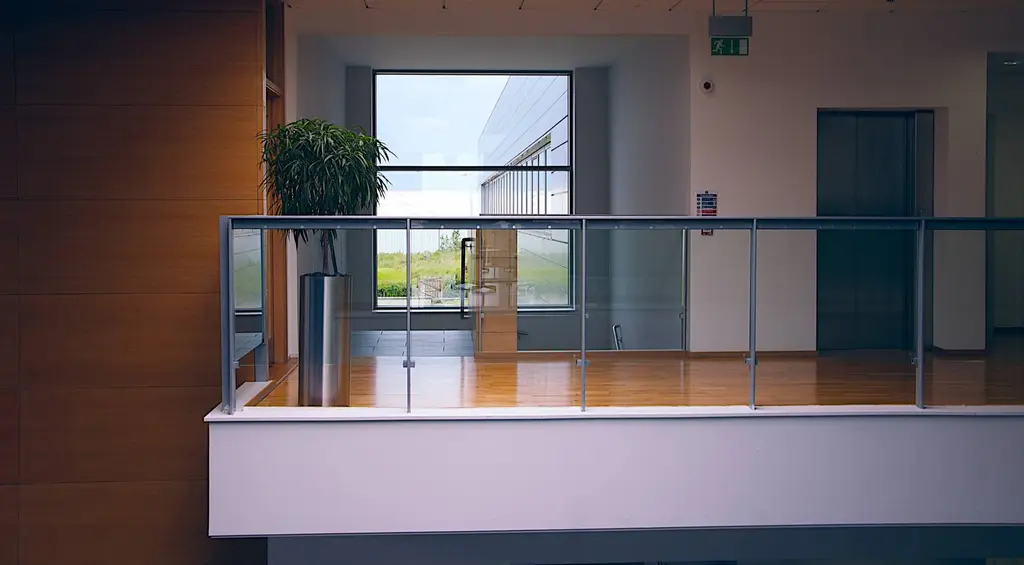 Office mezzanine walkway with glass balustrade, tailored commercial interior by CIC Ltd